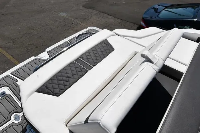 Slide: The Image of 2021 Monterey 278SS Super Sport boat with white and black seating, docked on pavement. - 5