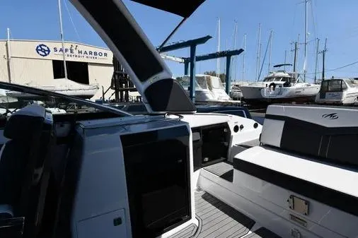 Slide: The Image of 2021 Monterey 278SS Super Sport boat at Safe Harbor, surrounded by yachts. - 27