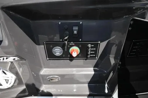 Slide: The Image of Control panel of a 2021 Monterey 278SS Super Sport boat, featuring switches and gauges. - 28