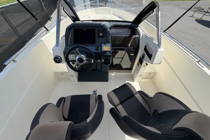 Slide: The Image of Interior view of 2021 Parker Poland 690 Sport boat cockpit with steering wheel and seats. - 17