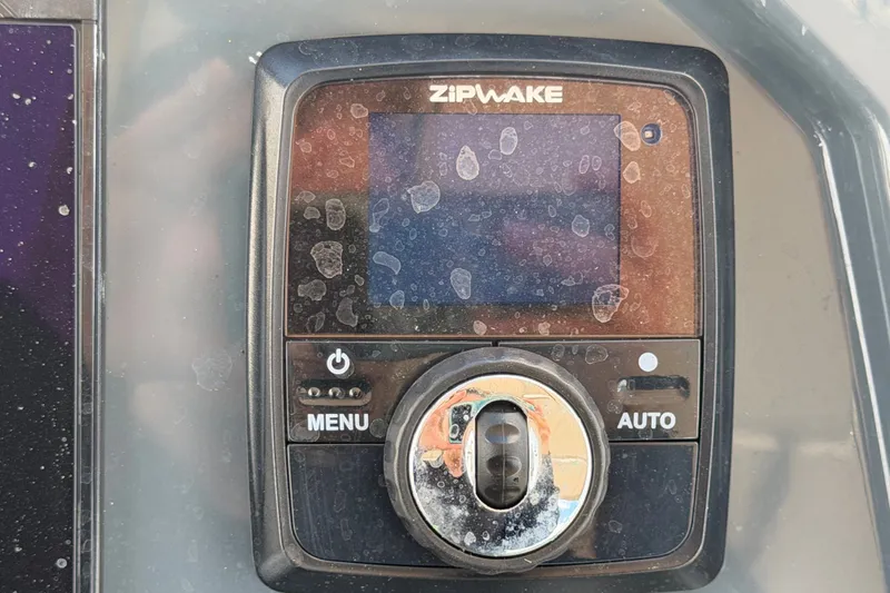 Slide: The Image of Control panel of a 2021 Parker Poland 690 Sport boat with Zipwake system. - 24