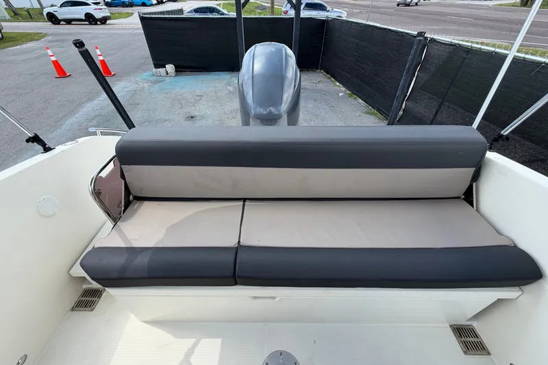 Slide: The Image of 2021 Parker Poland 690 Sport boat with cushioned seating and outboard motor. - 67