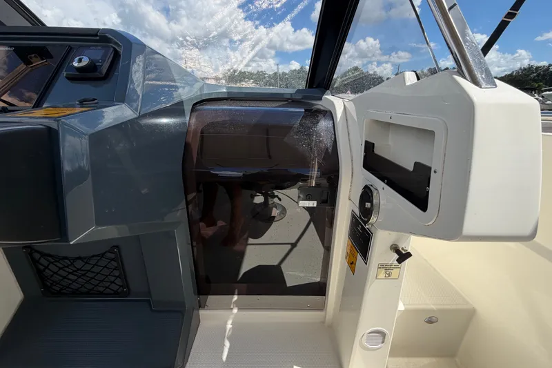 Slide: The Image of Interior view of 2021 Parker Poland 690 Sport boat cockpit with control panel. - 31
