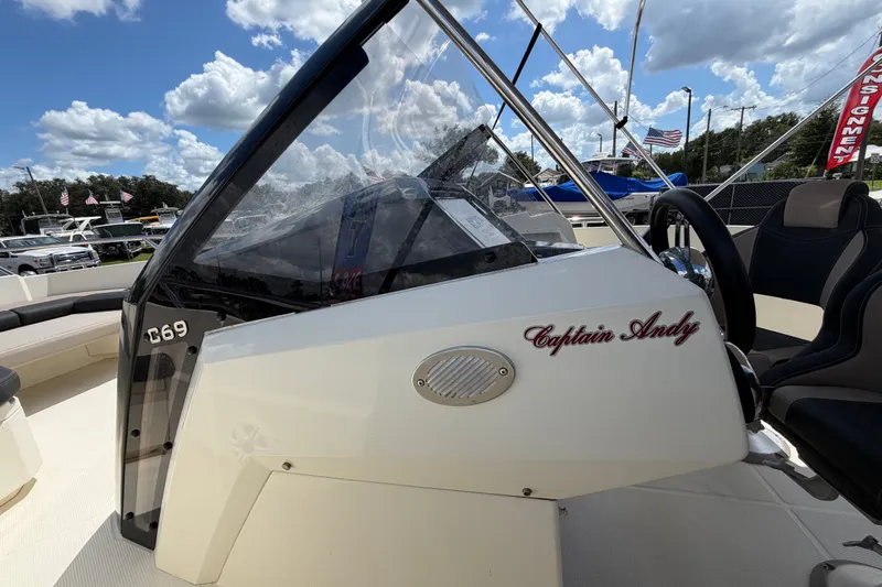 Slide: The Image of 2021 Parker Poland 690 Sport boat cockpit with "Captain Andy" inscription, under a blue sky. - 41