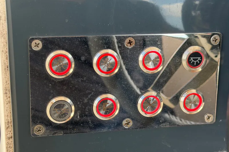 Slide: The Image of Control panel with buttons on a 2021 Parker Poland 690 Sport boat. - 23