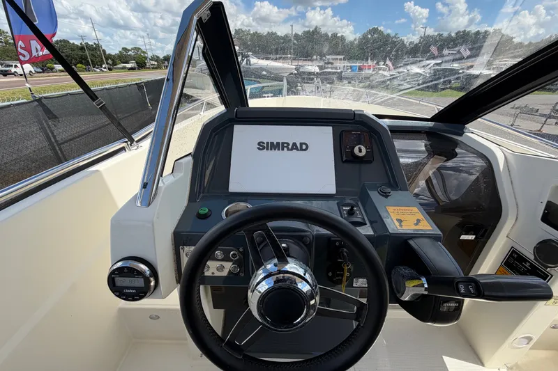 Slide: The Image of 2021 Parker Poland 690 Sport boat dashboard with Simrad navigation system. - 19