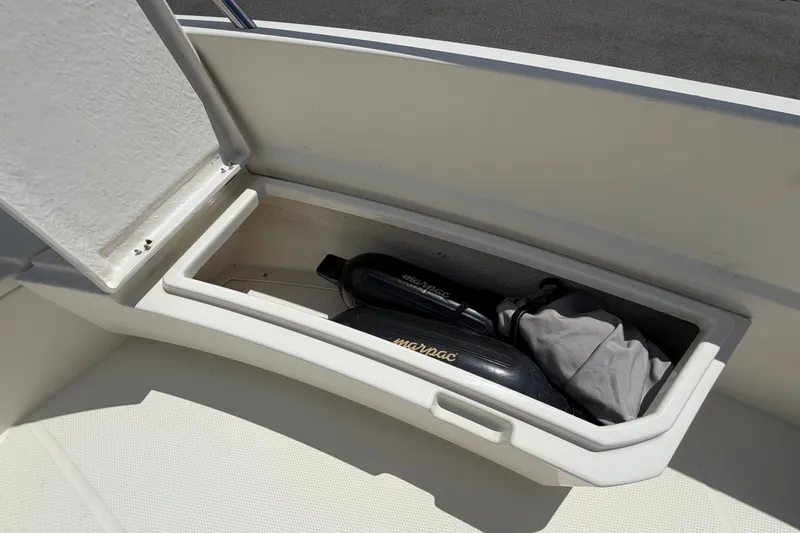 Slide: The Image of Storage compartment on a 2021 Parker Poland 690 Sport boat, containing equipment. - 54