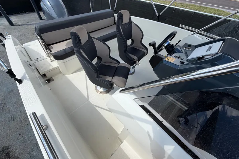 Slide: The Image of 2021 Parker Poland 690 Sport boat interior with dual seats and steering console. - 61