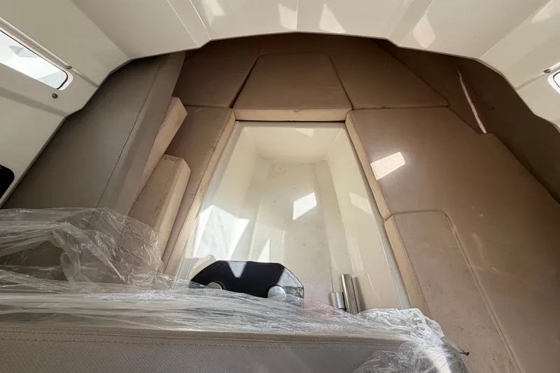 Slide: The Image of Interior cabin of 2021 Parker Poland 690 Sport boat, featuring beige cushions. - 35