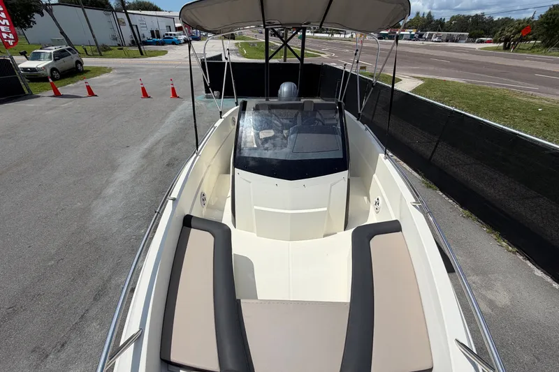Slide: The Image of 2021 Parker Poland 690 Sport boat with canopy, parked on a paved area. - 56