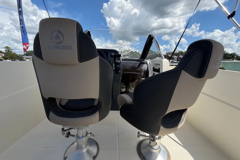 Slide: The Image of Interior of 2021 Parker Poland 690 Sport boat with two swivel seats under a blue sky. - 16