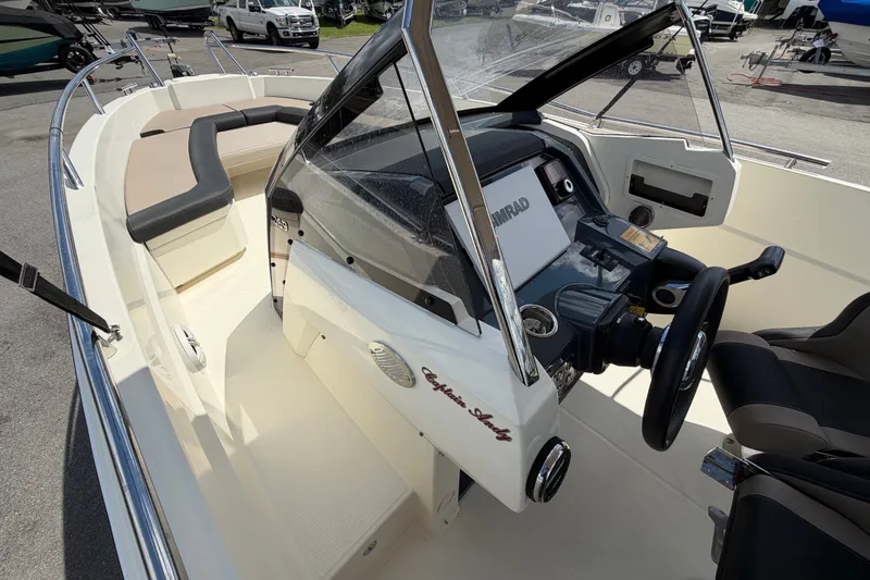 Slide: The Image of 2021 Parker Poland 690 Sport boat interior with steering console and seating area. - 40