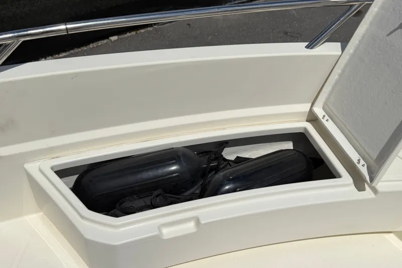 Slide: The Image of Storage compartment on a 2021 Parker Poland 690 Sport boat with fenders inside. - 46