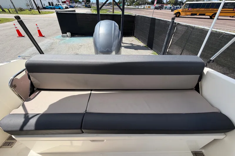 Slide: The Image of 2021 Parker Poland 690 Sport boat with cushioned seating, parked near traffic cones. - 68