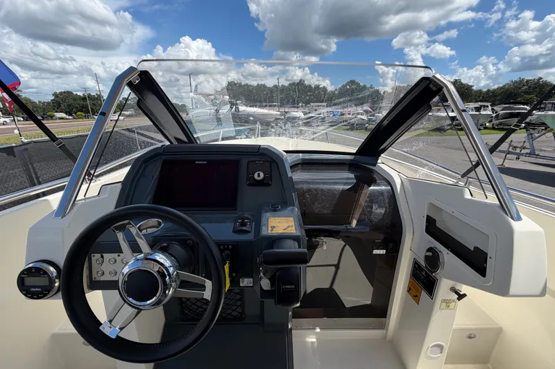 Slide: The Image of Cockpit view of 2021 Parker Poland 690 Sport boat under a partly cloudy sky. - 18