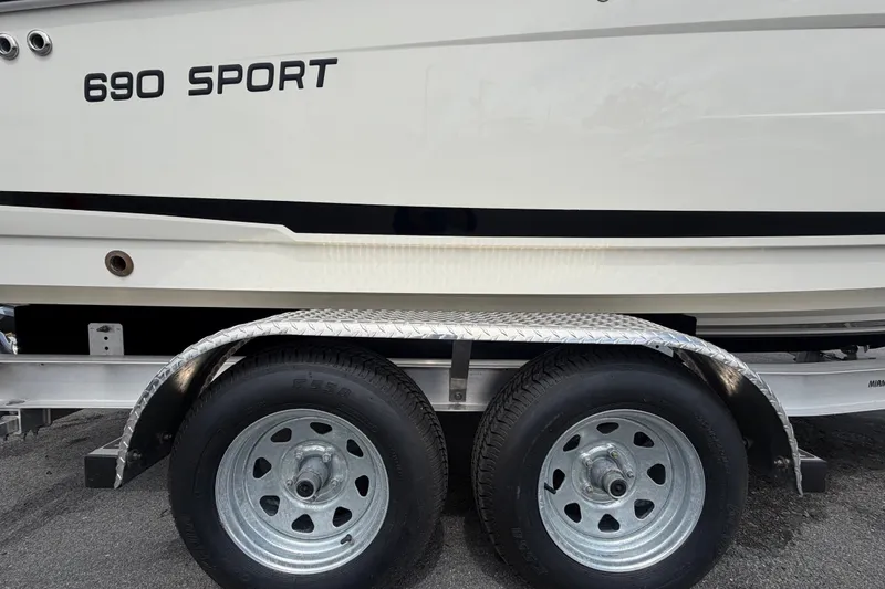 Slide: The Image of 2021 Parker Poland 690 Sport boat on a dual-axle trailer, side view. - 82