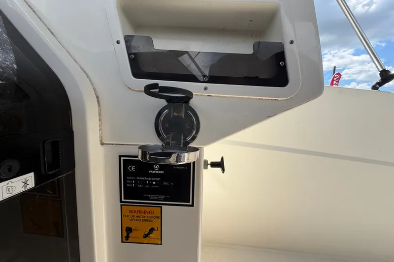Slide: The Image of Control panel of 2021 Parker Poland 690 Sport boat with warning label and hatch. - 32