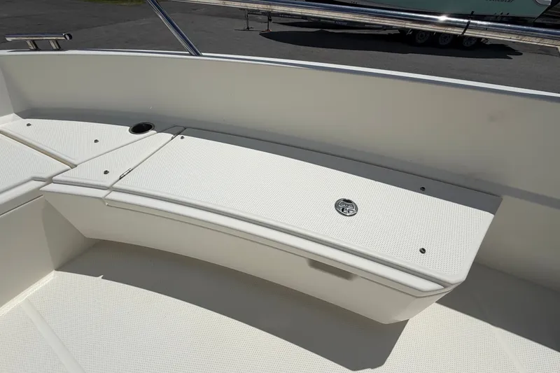 Slide: The Image of Parker Poland 690 Sport 2021 boat interior with white seating and storage compartment. - 53