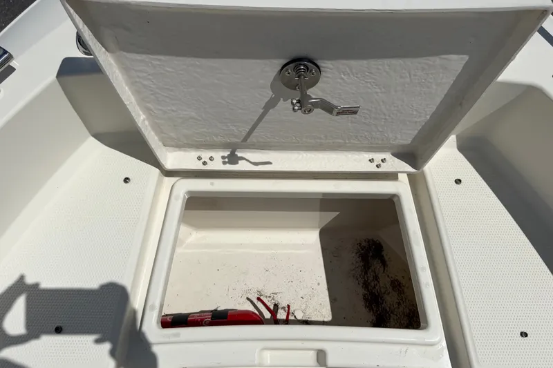 Slide: The Image of Open storage compartment on a 2021 Parker Poland 690 Sport boat. - 49