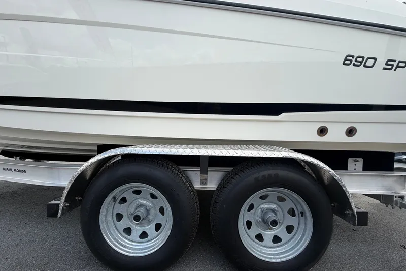Slide: The Image of 2021 Parker Poland 690 Sport boat on trailer, side view with dual wheels. - 81
