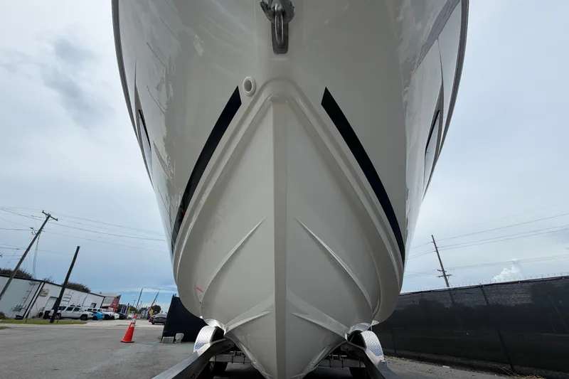 Slide: The Image of 2021 Parker Poland 690 Sport boat hull, viewed from below, on a trailer. - 9