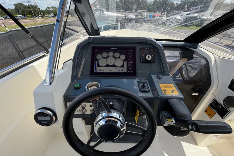 Slide: The Image of Cockpit view of 2021 Parker Poland 690 Sport boat with steering wheel and control panel. - 20