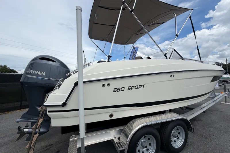 Slide: The Image of 2021 Parker Poland 690 Sport boat on trailer with Yamaha engine, side view. - 2