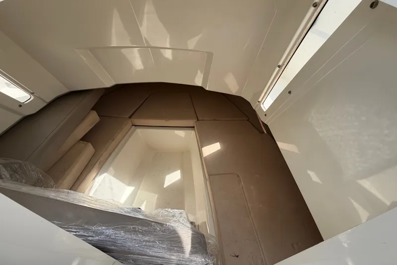 Slide: The Image of Interior cabin of 2021 Parker Poland 690 Sport boat, featuring seating and storage space. - 34