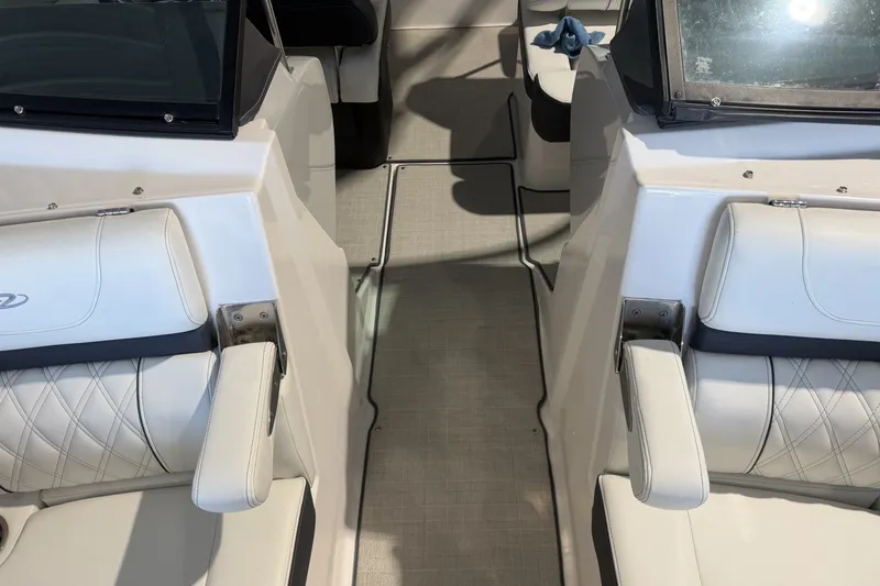 Slide: The Image of Interior of a 2021 Regal LS2 boat featuring white leather seating and sleek design. - 21