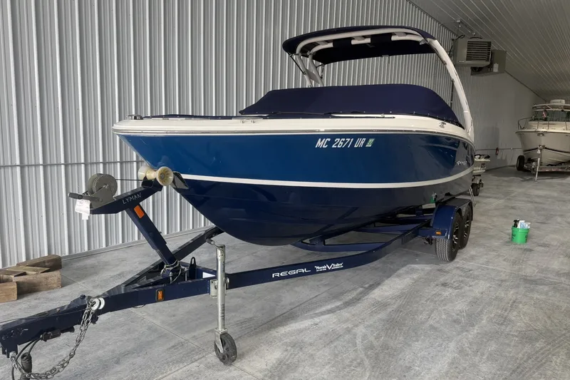 Slide: The Image of 2021 Regal LS2 boat on trailer in indoor storage facility. - 1