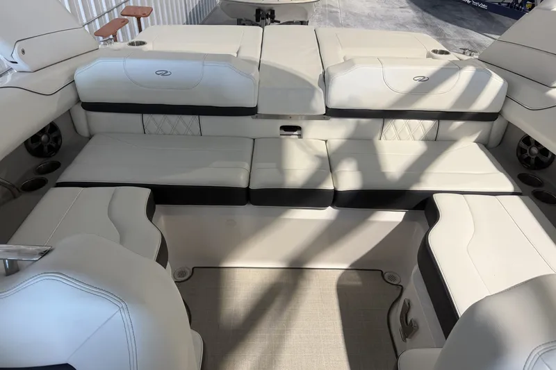 Slide: The Image of Luxurious seating area on a 2021 Regal LS2 boat, featuring elegant white upholstery. - 13