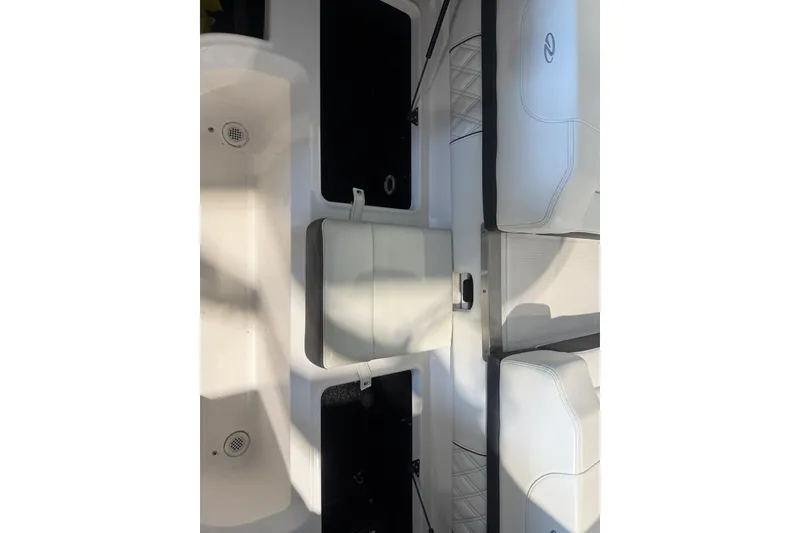 Slide: The Image of 2021 Regal LS2 boat interior with white seating and storage compartments. - 25
