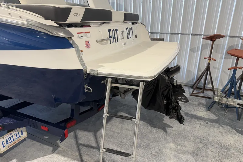 Slide: The Image of 2021 Regal LS2 boat with swim platform and ladder in a garage setting. - 3