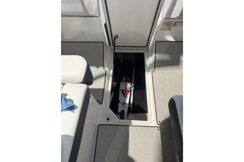 Slide: The Image of 2021 Regal LS2 boat interior with open storage compartment and seating area. - 22