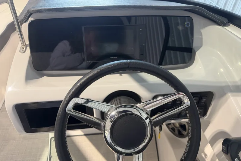 Slide: The Image of Steering wheel and dashboard of 2021 Regal LS2 boat with Garmin display. - 17