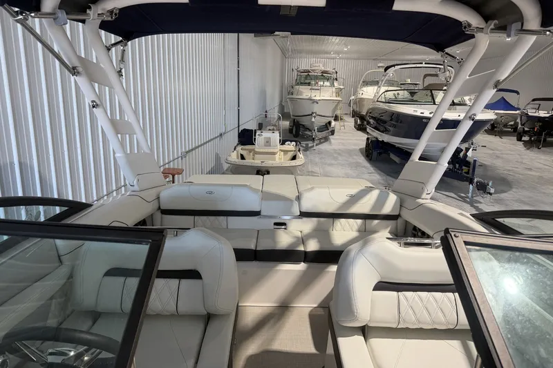 Slide: The Image of 2021 Regal LS2 boat interior in a storage facility with multiple boats. - 15