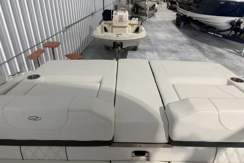 Slide: The Image of 2021 Regal LS2 boat interior with white seating in a storage facility. - 12