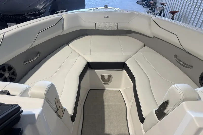 Slide: The Image of 2021 Regal LS2 boat interior with white cushioned seating and sleek design. - 19