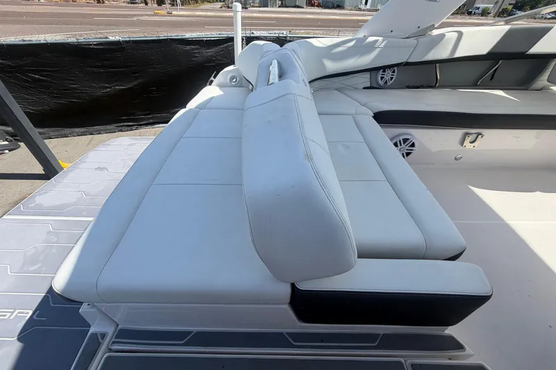 Slide: The Image of 2021 Regal 26 FasDeck boat interior with white cushioned seating. - 80