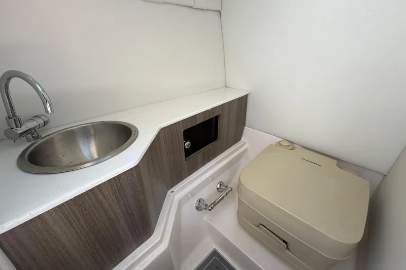Slide: The Image of 2021 Regal 26 FasDeck boat bathroom with sink and portable toilet. - 43