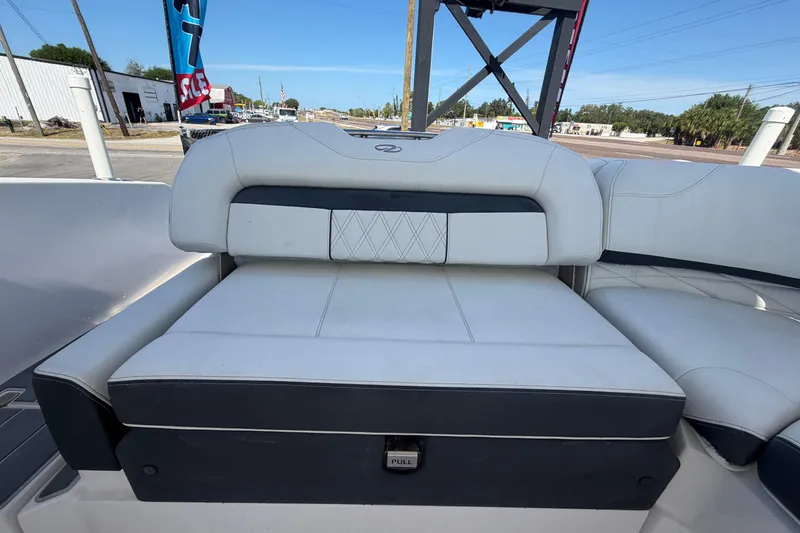 Slide: The Image of 2021 Regal 26 FasDeck boat interior seating with white and black upholstery. - 74