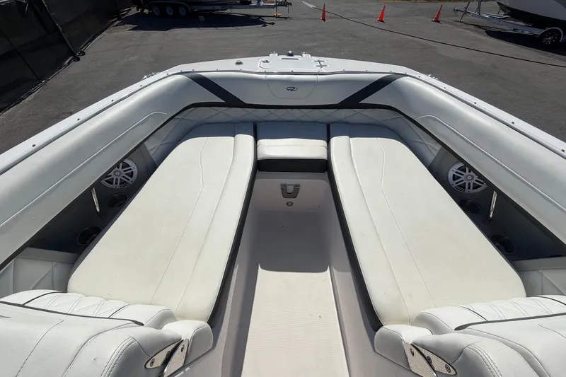 Slide: The Image of 2021 Regal 26 FasDeck boat interior with white seating and speaker system. - 46