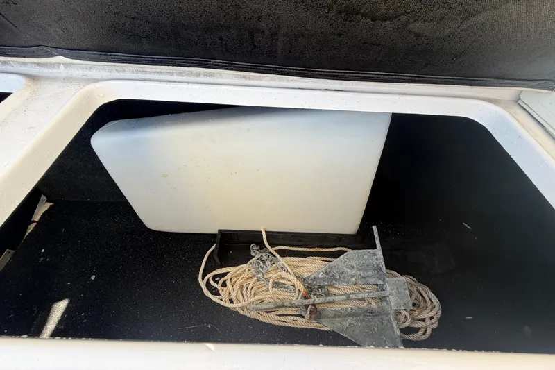 Slide: The Image of Storage compartment of 2021 Regal 26 FasDeck boat with anchor and rope. - 72