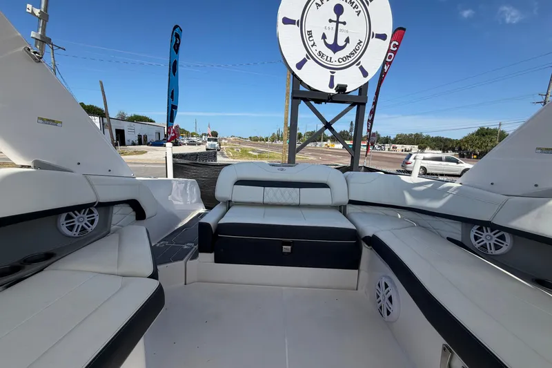 Slide: The Image of 2021 Regal 26 FasDeck boat interior with white seating and outdoor view. - 73