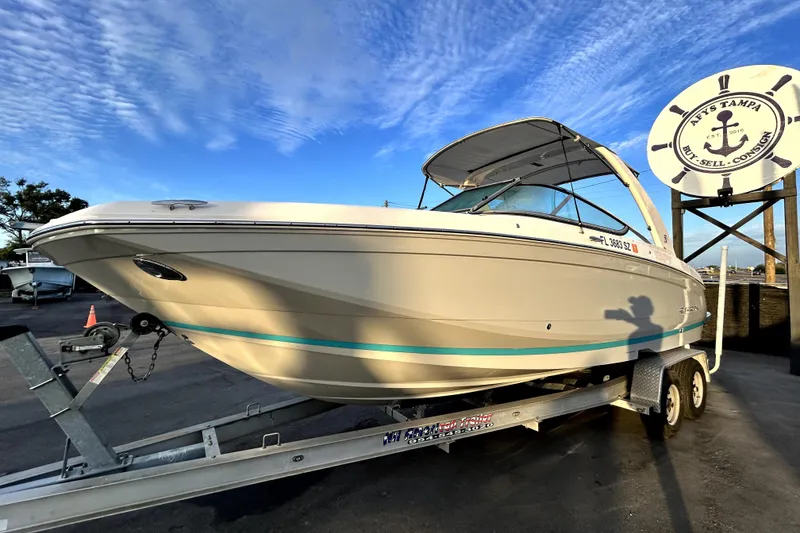 Slide: The Image of 2021 Regal 26 FasDeck boat on trailer under clear blue sky. - 8