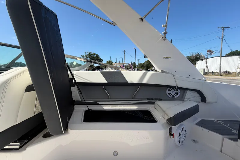 Slide: The Image of 2021 Regal 26 FasDeck boat interior with open storage compartment and seating. - 68