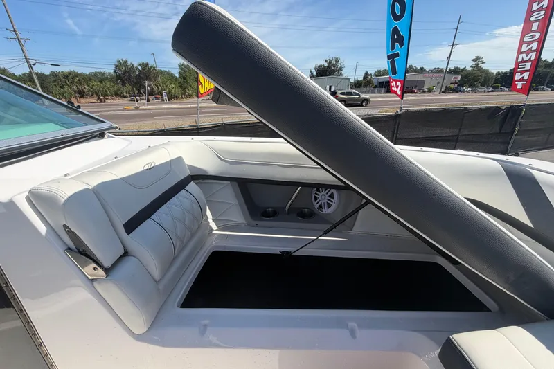 Slide: The Image of 2021 Regal 26 FasDeck boat interior with white seating and storage compartment. - 54