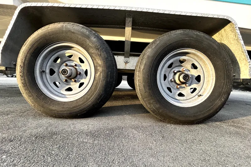 Slide: The Image of Trailer wheels for 2021 Regal 26 FasDeck boat on pavement. - 83