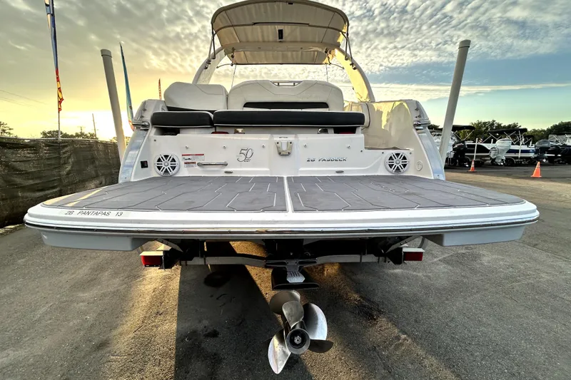 Slide: The Image of 2021 Regal 26 FasDeck boat rear view with swim platform at sunset. - 3