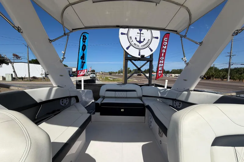 Slide: The Image of 2021 Regal 26 FasDeck boat interior with sale signs in background. - 65